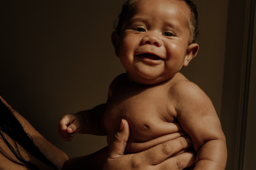 Baby facing forward and smiling