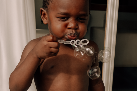 Baby blowing bubbles